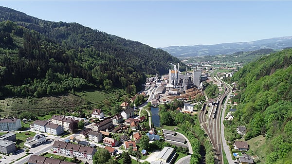 aerial view of a Mondi production site set against a green countryside and blue skies